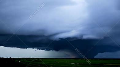 Storm Cell Moves Across Green Field in the Evening