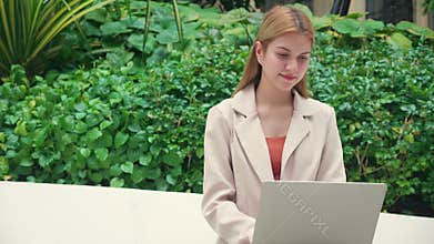 Young caucasian businesswoman working laptop sitting park, freelancer or digital nomad, remote work technology online, business