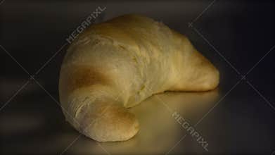 Timelapse baking of single golden and crisp croissant