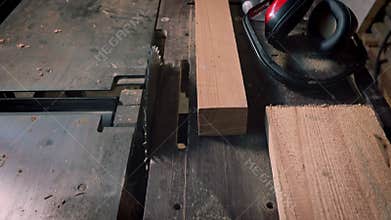 A sawmill is where a protective mask and headphones are located.