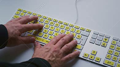 Hands typing on a Braille keyboard. Close-up, fingers moving across tactile keys