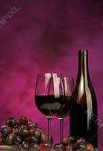 Vertical of Wine bottle with glasses and grapes