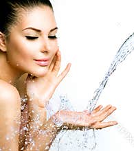 Beautiful smiling girl under splash of water