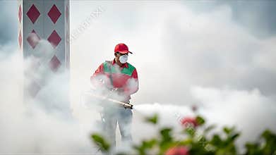 Fogging operation worker spraying insecticide with fogging machine