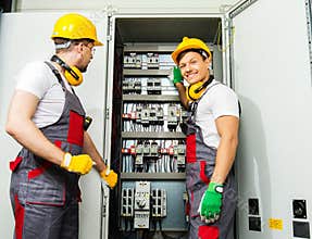 Two electricians on a factory