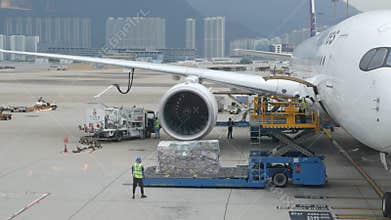 View at airside in HKG Hongkong Airport while ground service staffs loaders doing ground service operation of Philippines airline