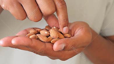 Healthy eating with fresh almonds in hand