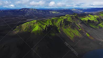 Aerial drone over Iceland volcanic plains with mossy crater ridges