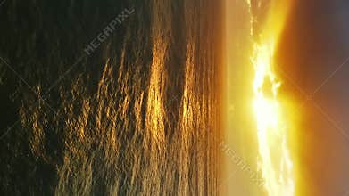 Aerial view on big waves and dramatic sunset sky