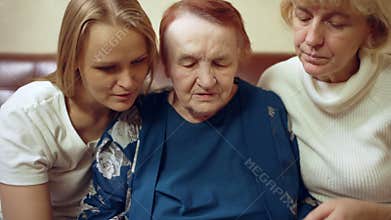 Women of different age looking through old family