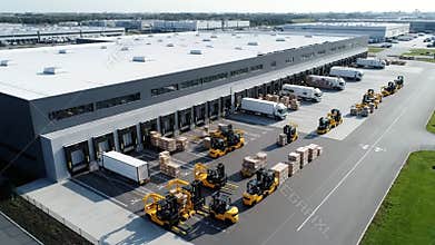 Busy Logistics Warehouse Exterior With Forklifts Trucks And Shipping Containers Receiving Goods On A Bright Sunny Day
