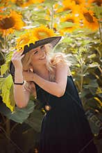 Beautiful woman between sunflowers