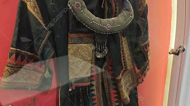 Ancient traditional costume with ethnic embroidery and ornate jewelry on display. Historical artifact representing a