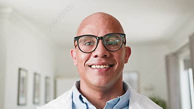 Happy Bald Man In Glasses Smiling Confidently Towards Camera In Bright Room