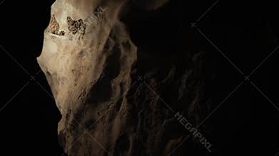 Meditation in a cave texture with stalactites and stalagmites in darkness.