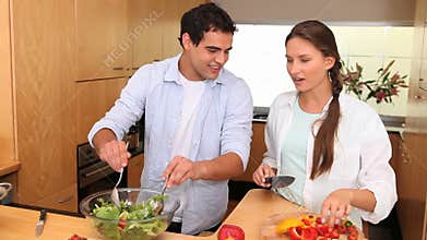 Couple preparing a salad with peppers