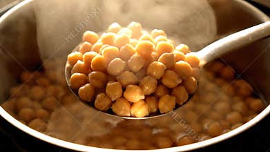 Steaming Pot of Chickpeas with Ladle Boiling on Stove Top Cooking Food Preparation Kitchen Backdrop Close Up Shot
