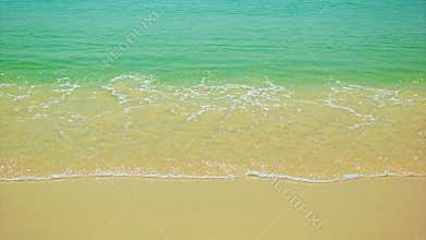 Warm sea surf with clear water and golden sand