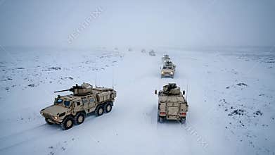 Military tanks convoy in a snowy landscape - High quality stock photo