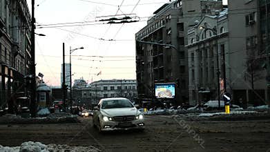 Cars and buses move through city traffic on dirty snow during winter conditions in central Belgrade. Belgrade, Serbia 9 January