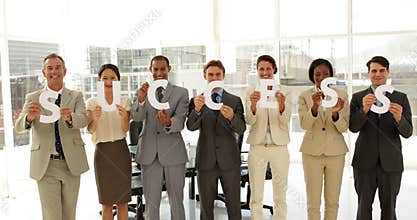 Business team holding letters spelling success
