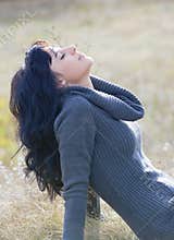 Beautiful young woman in front of fall background