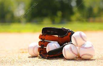 Baseballs and Glove on Field