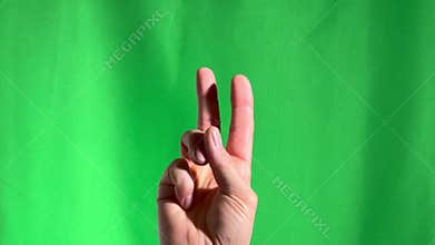 Counting fingers. Hand gesture, sign. Close-up on chromakey green