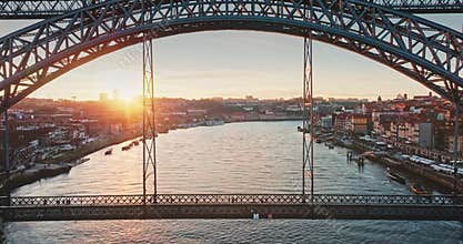 Dom Luis I Bridge spanning Douro River at sunset in Porto Portugal