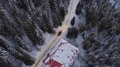 Professional services snow plow truck maintaining safe road conditions under streetlights during nighttime