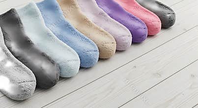 Soft plush slippers in various colors on a wooden floor for indoor comfort and relaxation