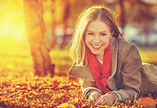 Happy young beautiful woman in the autumn