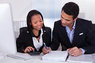 Two business people doing finance work