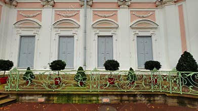 Symmetrical Rococo Pavilion Facade with Four Arched Windows and Green Railing