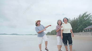 Group senior asian woman laughing and playing together at beach, enjoy vacation with friendship after retirement, cheerful elderly