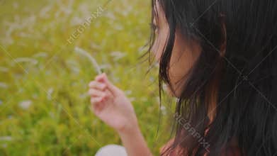 Young Woman Contemplating Nature in a Windy Meadow