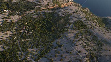 Aerial view of a dramatic canyon with turquoise water surrounded by rugged rocky cliffs and sparse vegetation