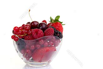 Bowl of red summer fruits or berries.