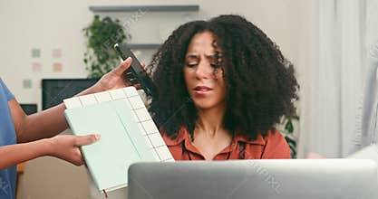 Diverse Businesswoman Overwhelmed by Work Demands and Tech in a Busy Startup Office