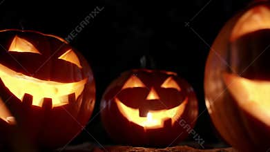 Glowing Jack-o-Lanterns with Flickering Candles at Night
