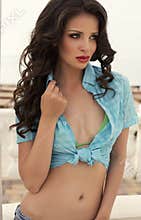 Beautiful girl with black hair posing on beach