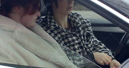 Women swap keys, Front seat exchange captures crucial decision moment