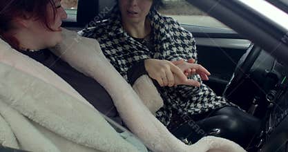 Closeup of female hands inspecting jewelry and enjoying conversation