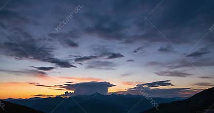 Observing the delicate dance of wispy cirrus clouds, gracefully streaking across an expansive deep blue firmament, evoking a