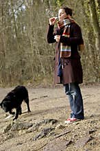 Girl, soap bubbles and wet black dog