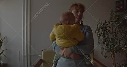 Mother Soothes Crying Baby Boy in Cozy Apartment, Providing Comfort and Reassurance