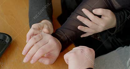 Friendly wrist gesture at table, Calm and caring touch between friends