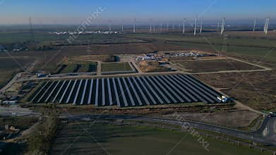 Solar panels wind turbines generating energy. Majestic aerial view drone