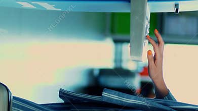 Close-up, woman, with luggage, checks in at automated check-in counter, booth at