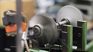 Turbocharger turbine wheel spinning rapidly on a dynamic balancing machine